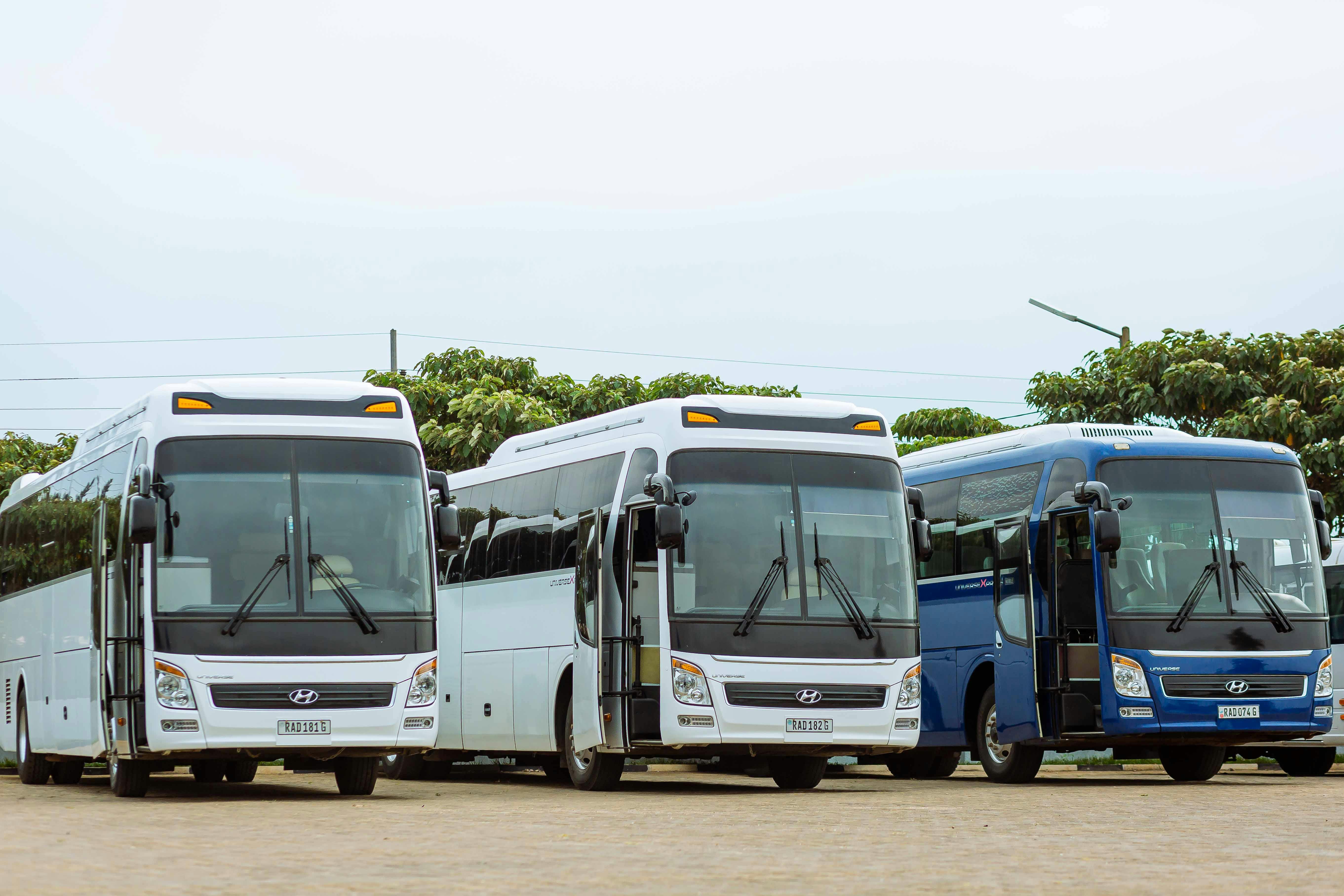 EBus Booking Ticket - Modern luxury coach bus traveling through scenic East African landscape with mountains and sunset